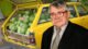 Math professor standing in front of car loaded with watermelons